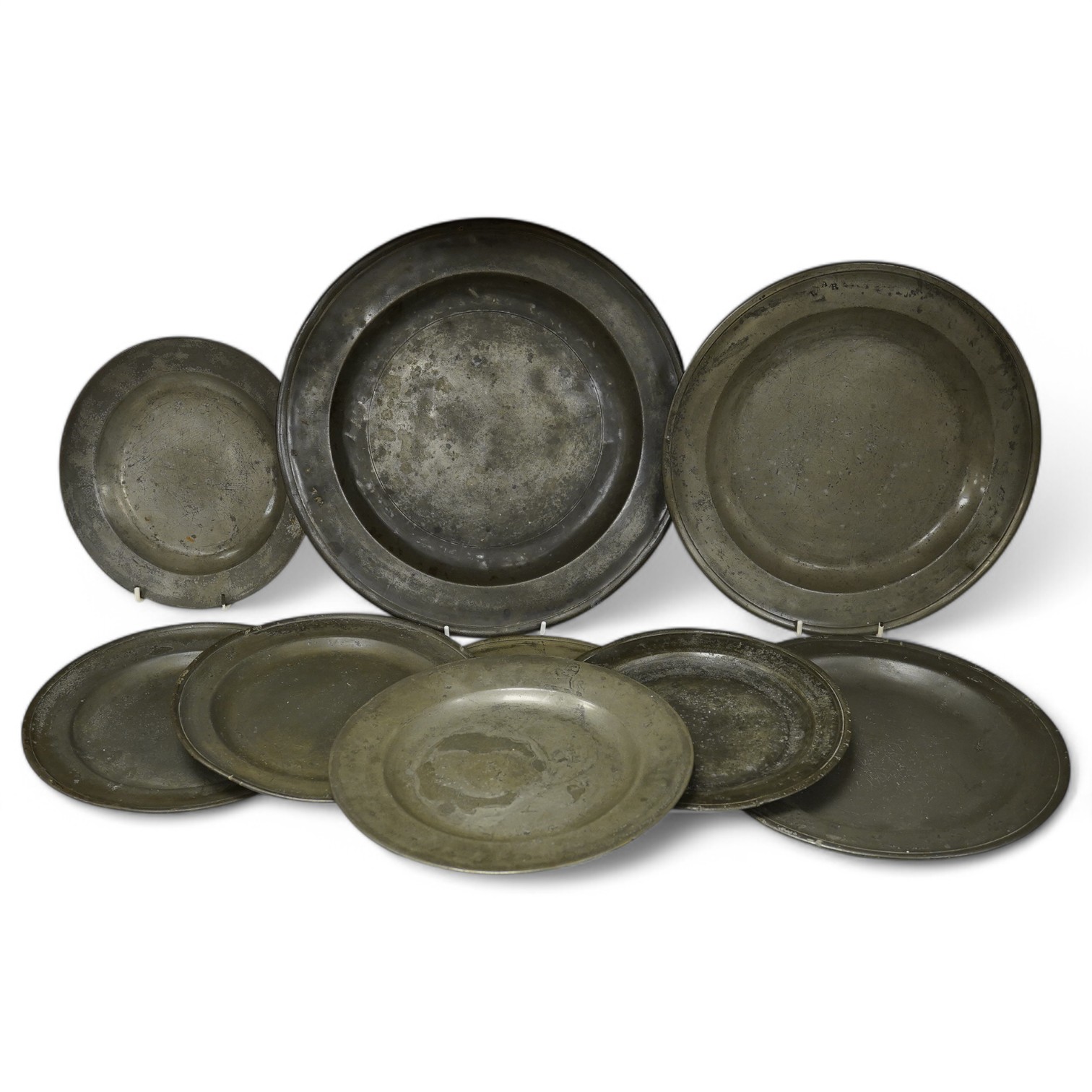 A collection of 18th and 19th century pewter plates, largest 34.5cm diameter (9). Condition - good considering age and use